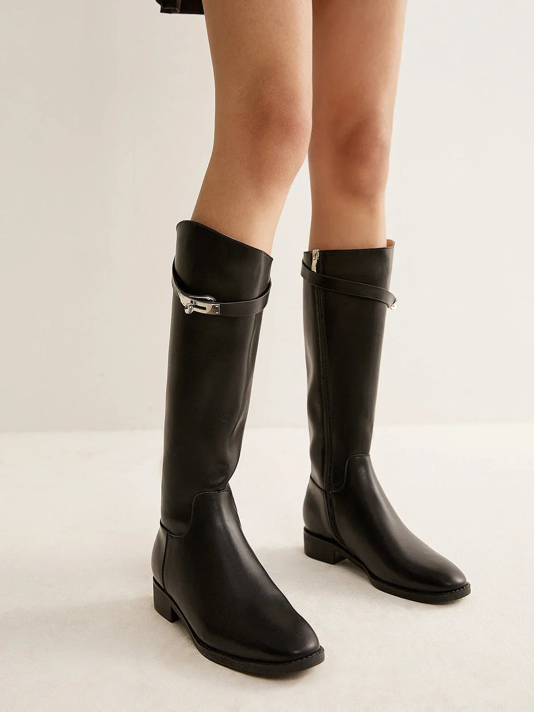 Black riding-style boots with buckle detail
