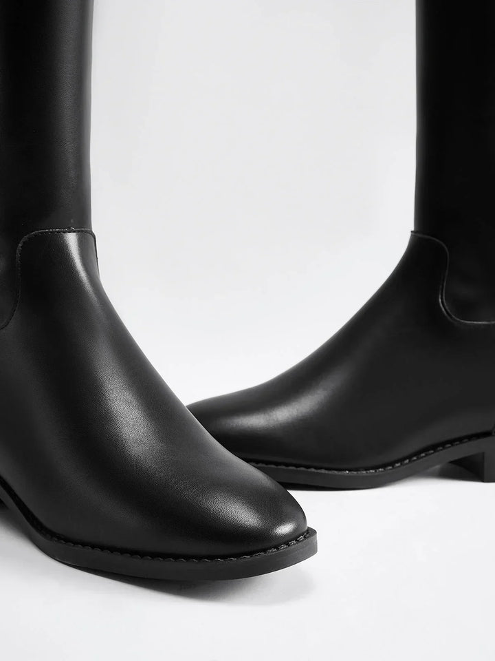 Black riding-style boots with buckle detail