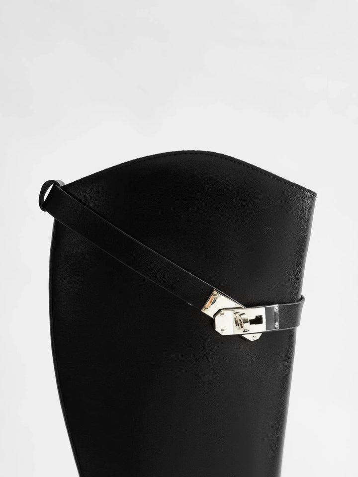 Black riding-style boots with buckle detail
