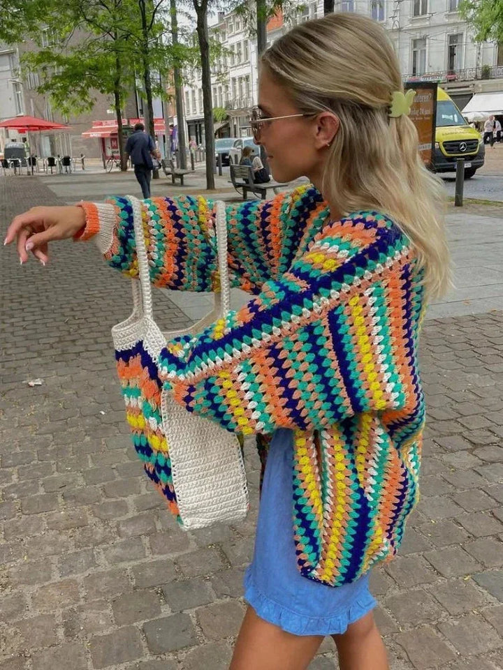 Women's knitted cardigan with rainbow stripes.