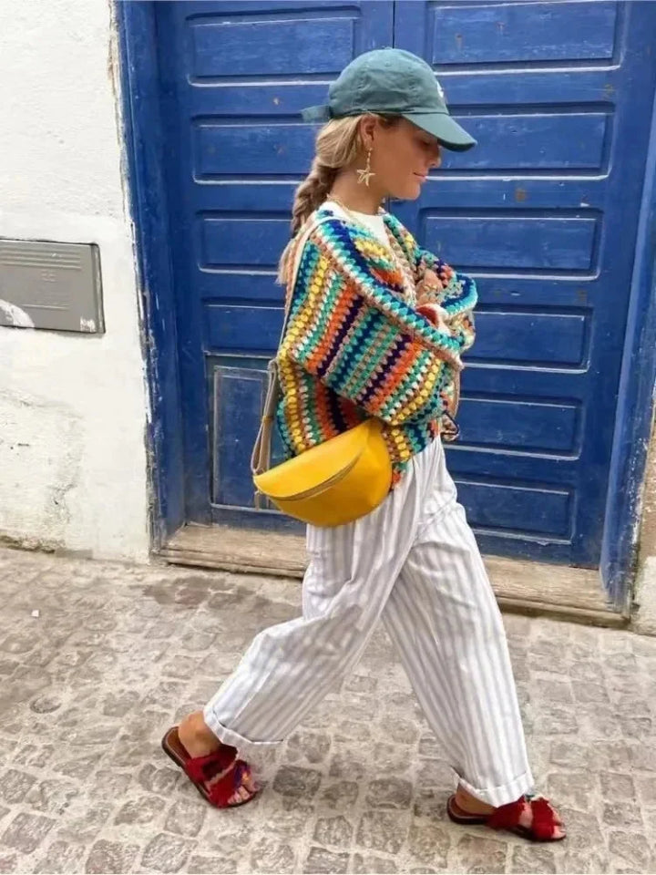 Women's knitted cardigan with rainbow stripes.
