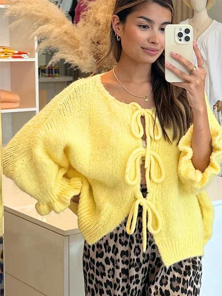 Women's yellow cardigan with bows and an open front