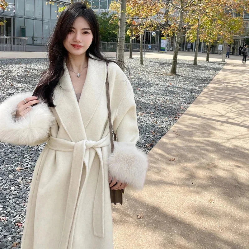 Long belted coat for women with faux fur sleeves