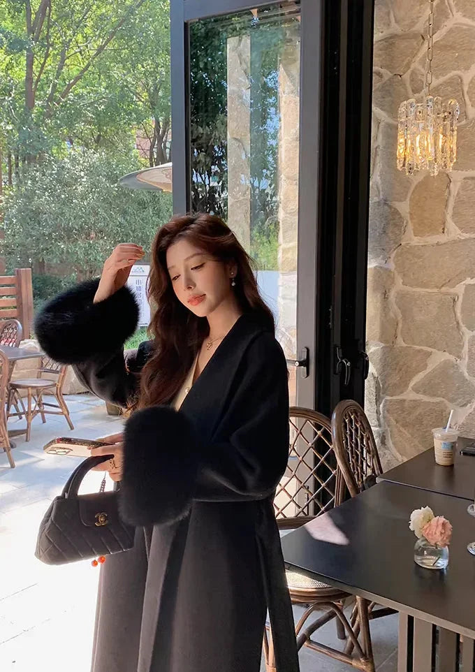 Long belted coat for women with faux fur sleeves