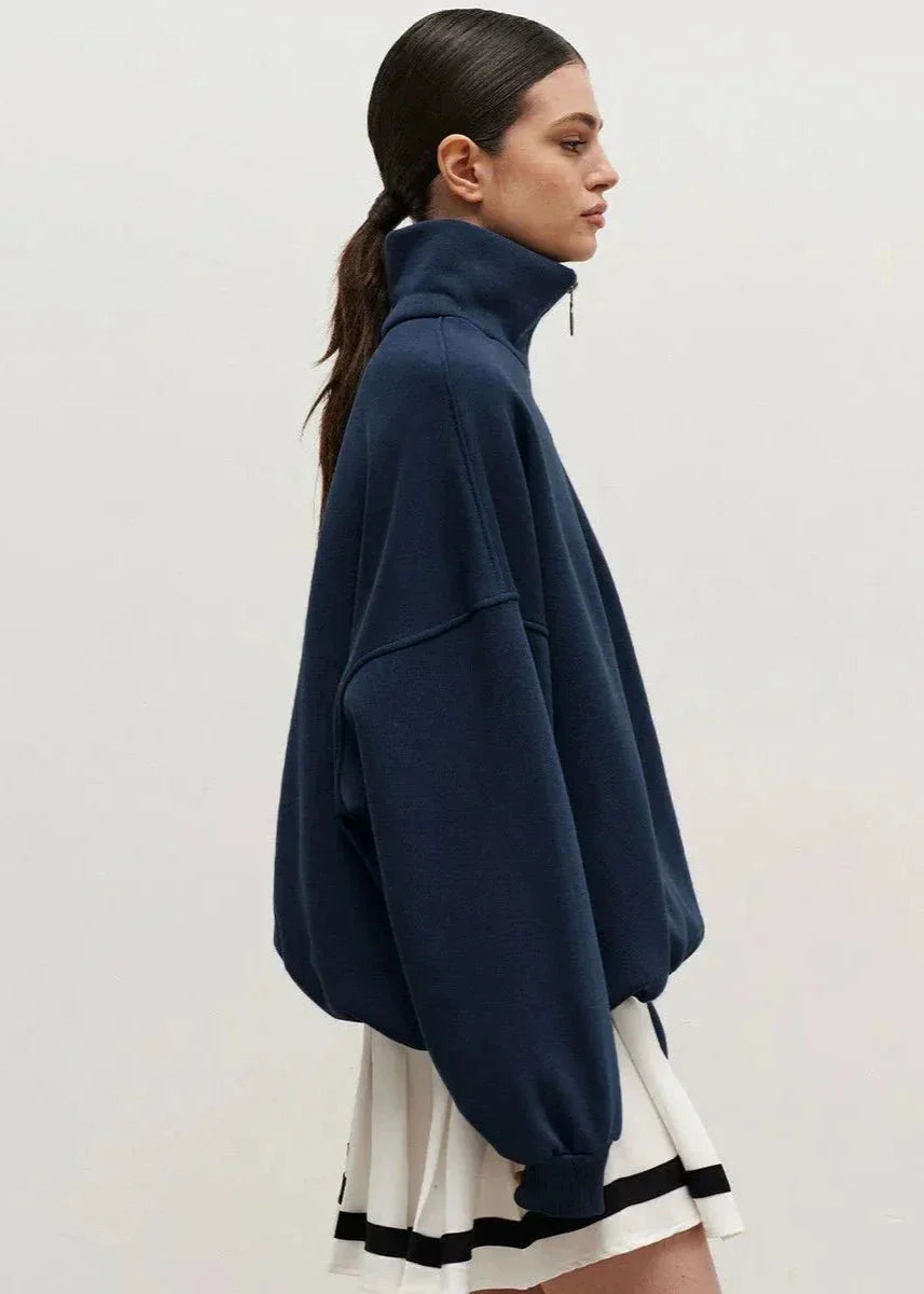 Navy blue zip-up sweater with a relaxed fit