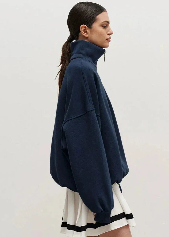 Navy blue zip-up sweater with a relaxed fit