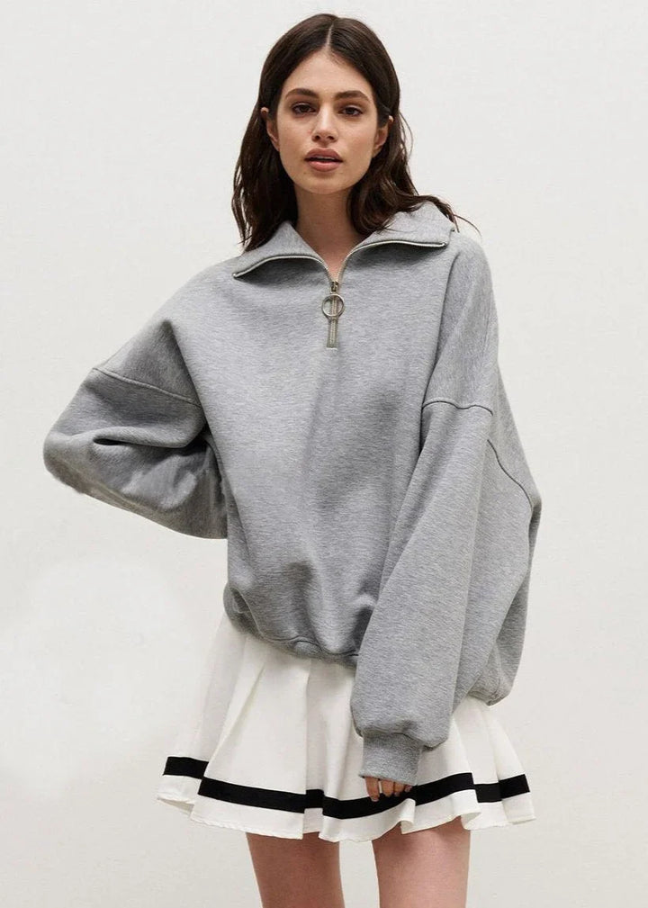 Navy blue zip-up sweater with a relaxed fit