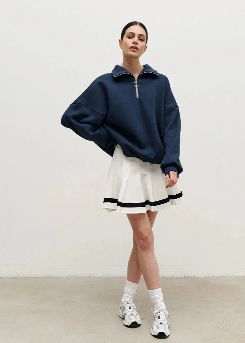 Navy blue zip-up sweater with a relaxed fit