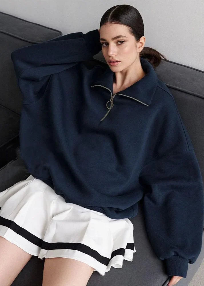 Navy blue zip-up sweater with a relaxed fit