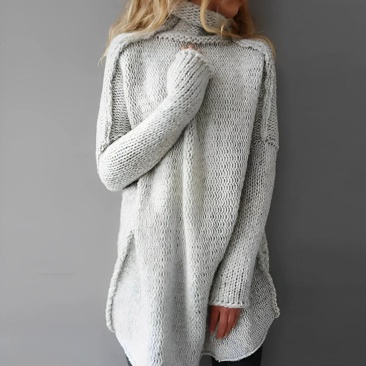 Long women's knitted sweater with a stand-up collar