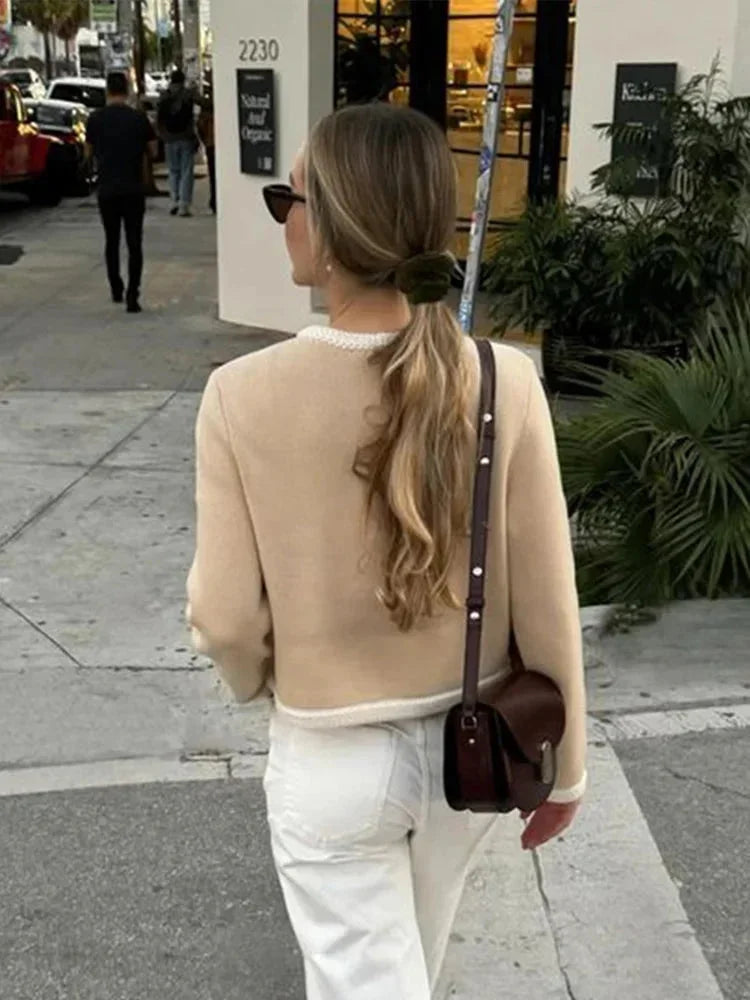 Short beige tweed women's blazer with buttons