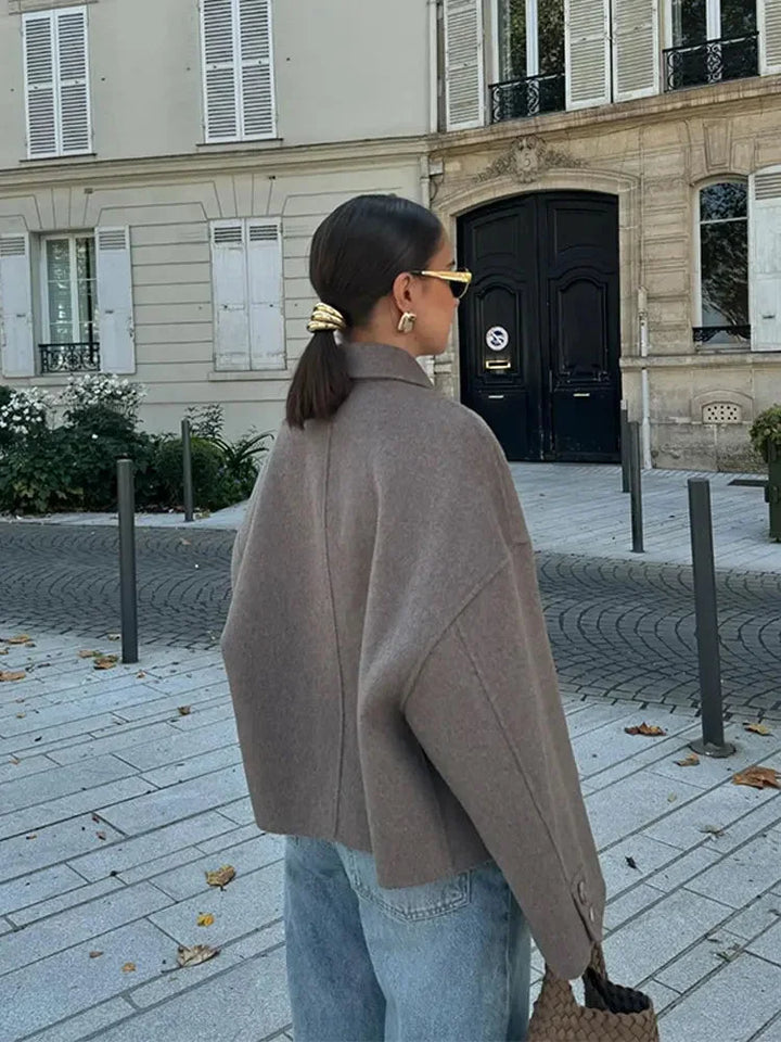 Modern women's blazer with a loose fit and buttons.
